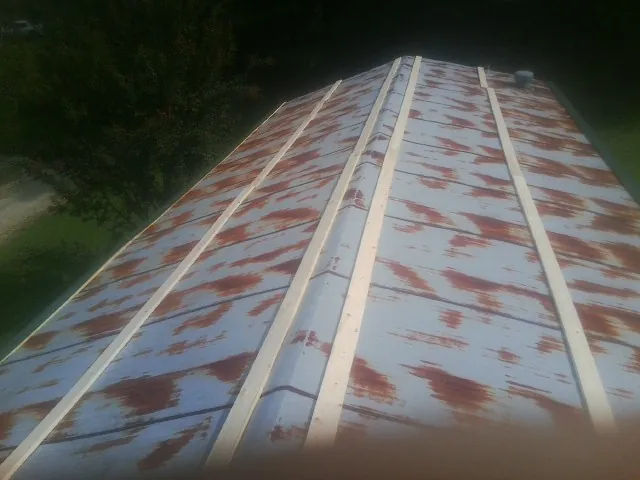 Rusted metal roof panels with new wood purlins before replacement — Storm Damage Roof Repair in Federalsburg by Roofing Brothers